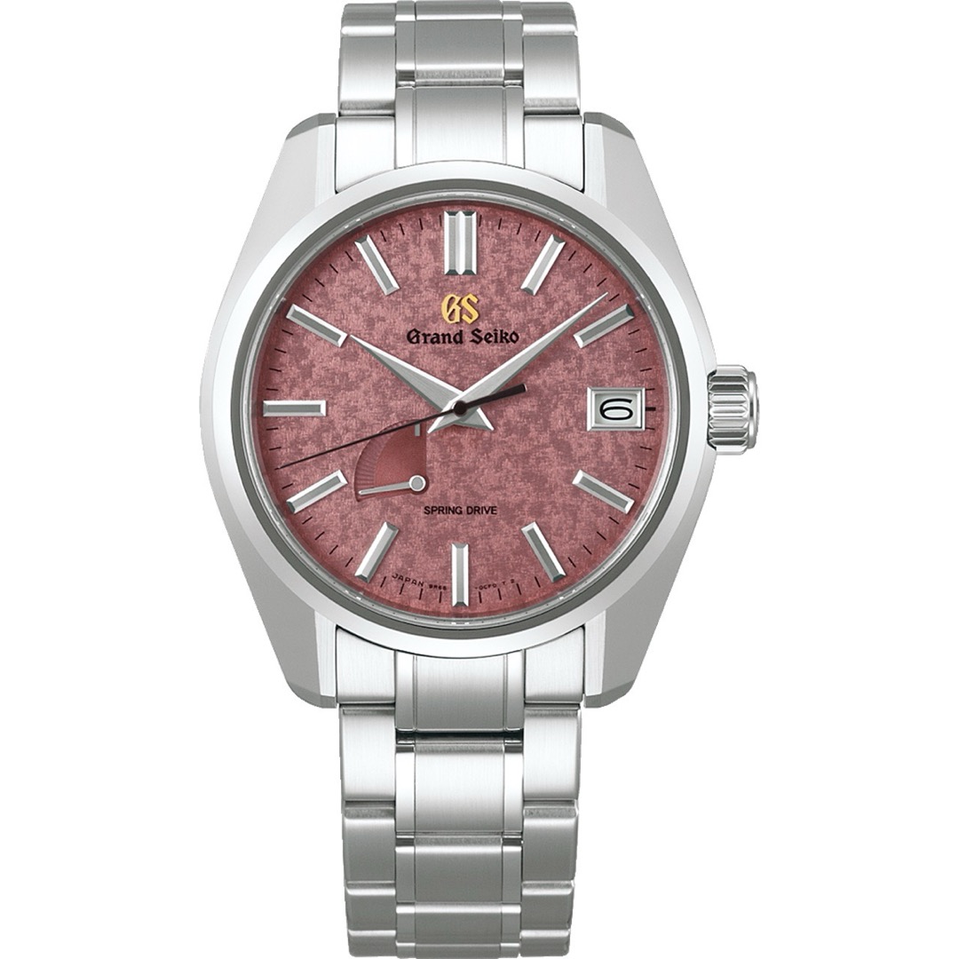 A Grand Seiko SBGA509 seen head on, its dusty rose dial finely granular, with a power reserve arc near eight, a date window at three and a broad shouldered polished case