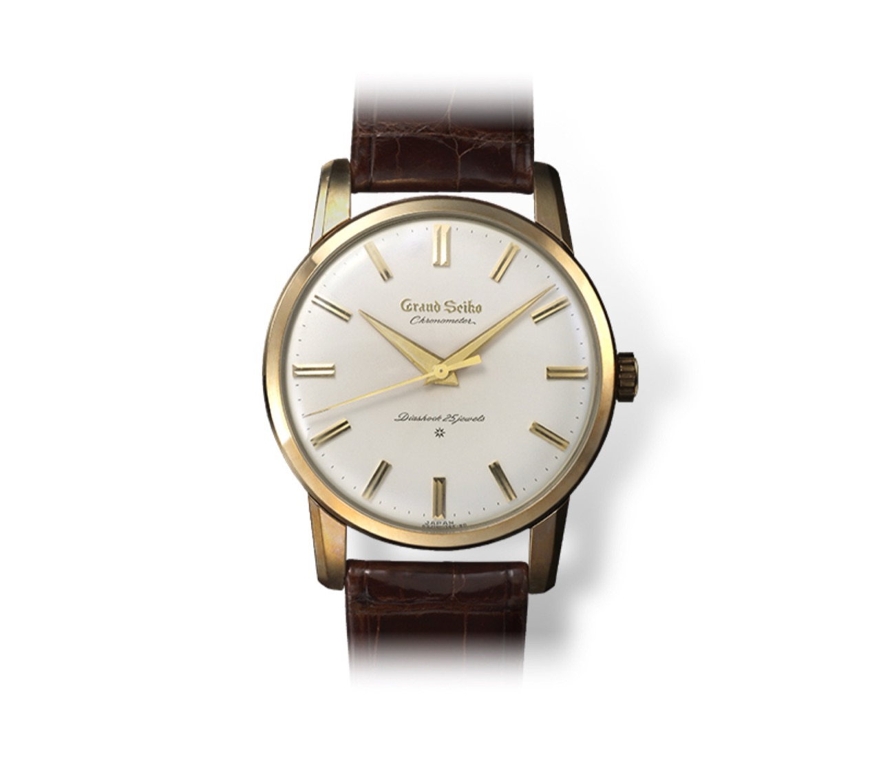The first Grand Seiko of 1960, a gold-cased watch on a brown crocodile strap, its silvered dial carrying Grand Seiko in gold script above Chronometer and Diashock 25 Jewels printed in dark ink