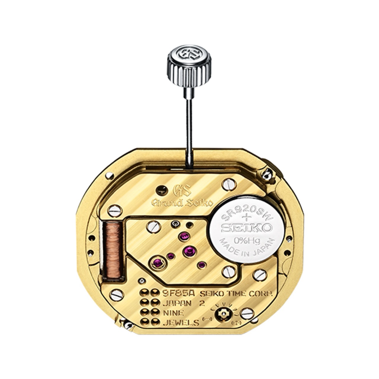 The 9F85 quartz caliber out of its case, its gold-coloured plate finished with fine diagonal stripes and a chamfered polished edge, with ruby jewels, a copper coil and a silver battery